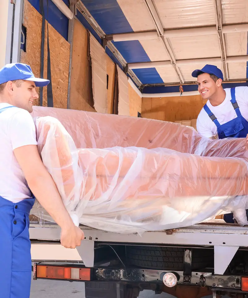 loaders taking furniture from truck